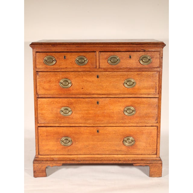 Antique George III style oak chest of drawers, 19th century. With a two board top with thumb molded front and side edges,...