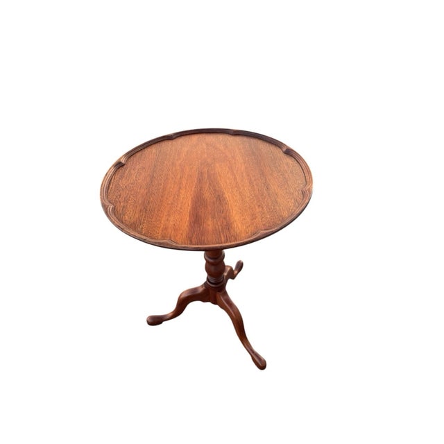 Vintage 1940s walnut side table in Georgian style featuring a round pie-crust edge and elegant tripod pedestal base....