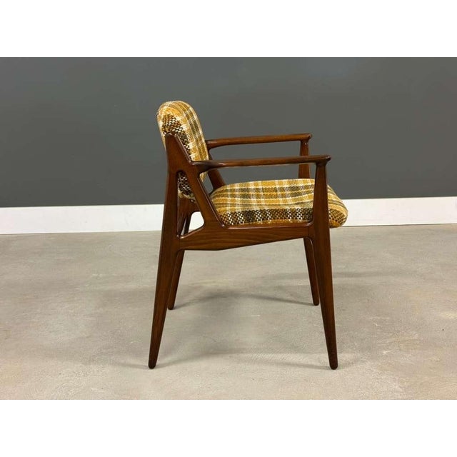 A mid century modern solid beech attributed to Elle and Ella dining chair with a tilting back designed by Arne Vodder....