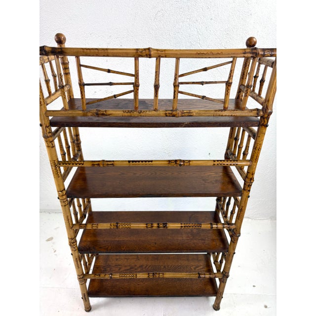 This is an early 20th century handcrafted bamboo and oak etagere. This etagere features delicate handcrafted bamboo...