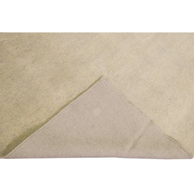 Beautiful Moroccan style handmade wool rug with a beige field featuring a gorgeous Solid boho design. This rug measures:...