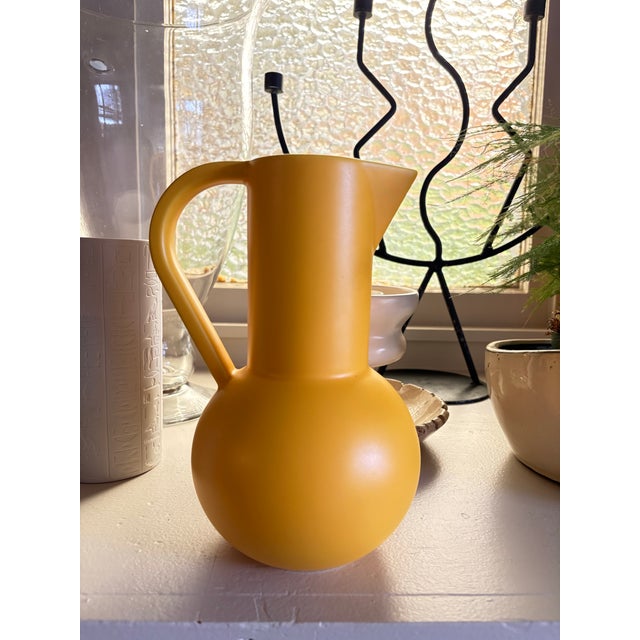 Designed by Danish brand raawii, this Strøm collection ceramic pitcher features a sculptural silhouette and a rich matte...