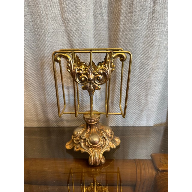 Vintage Hollywood Regency era has made gold floral and scroll design pedestal design guest towel holder. Guest powder room...