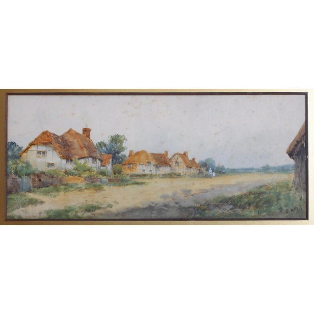 Early 20th century English village scene watercolor by S. Hart. A charming English village of thatched roof cottages, a...