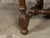 An English oak coffee table from the 19th century with single drawer, wooden pulls and turned base. Created in England...