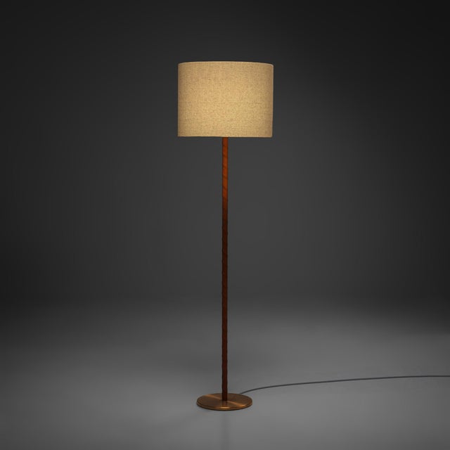 An elegant floor lamp designed by Uno & Östen Kristiansson for Luxus in Sweden during the 1960s. Characterised by its...