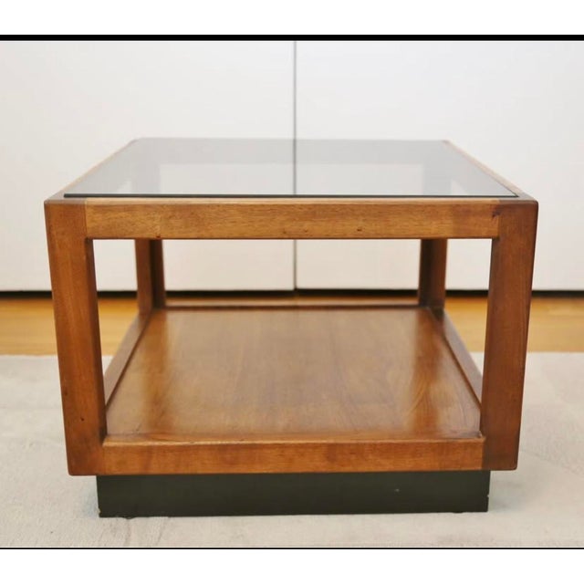 This 1960s Mid-Century Modern floating cube walnut side table, attributed to Adrian Pearsall, features a smoked glass top...