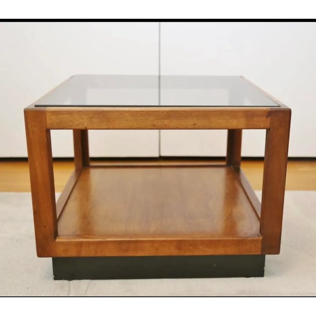 This 1960s Mid-Century Modern floating cube walnut side table, attributed to Adrian Pearsall, features a smoked glass top...