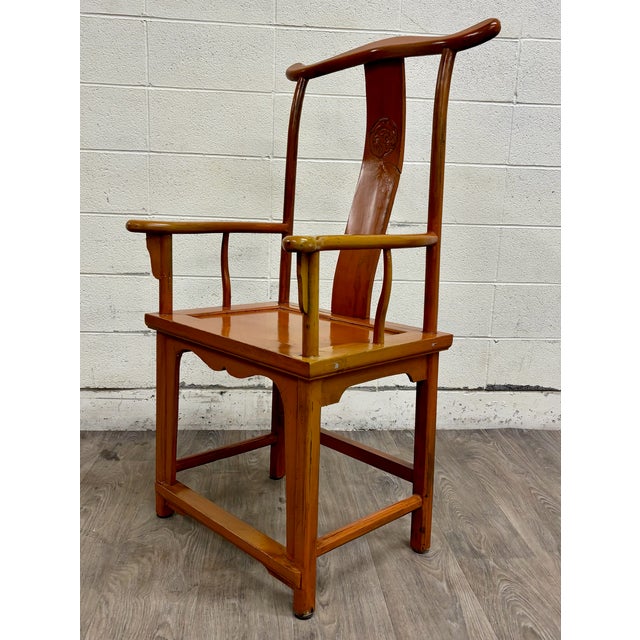 This is a striking antique Chinese Ming style horseshoe-back armchair. It features a warm lacquered finish, curved crest...