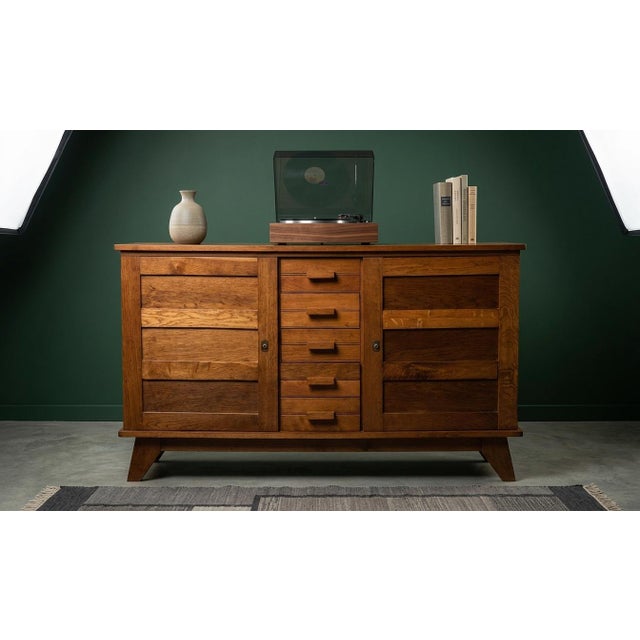 A exceptional and beautifully preserved example of mid-century French modernism, this large oak sideboard was designed by...