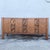 This mid century Brutalist credenza by United Furniture Corporation balances sculptural artistry with refined...