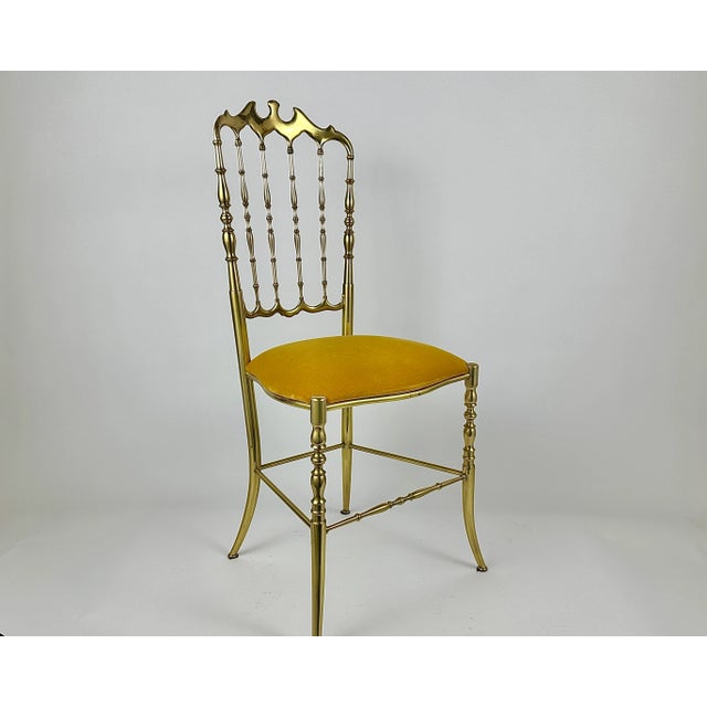 Beautiful antique French bronze Chiavari spindle back chair with padded seats upholstered in golden velvet fabric. These...