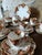 An elegant antique English tea service by Melba China, England, dating from the early 20th century. This charming set...