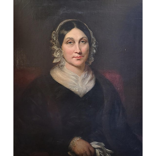 Original, mid-19th century portrait of a seated lady in a lace bonnet holding white gloves. The medium is oil on canvas....