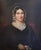 Original, mid-19th century portrait of a seated lady in a lace bonnet holding white gloves. The medium is oil on canvas....
