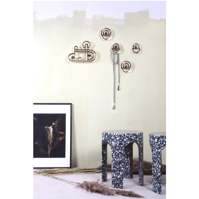 This set of two bronze hooks was designed by Alessandro Zambelli and made in Italy. It is reminiscent of the architecture...