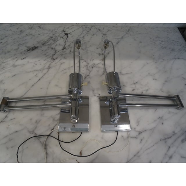Pair of classic Hansen New York Double Swing Arm Wall Lights Designed by George Hansen in the 1960s-1970s. Manufactured by...