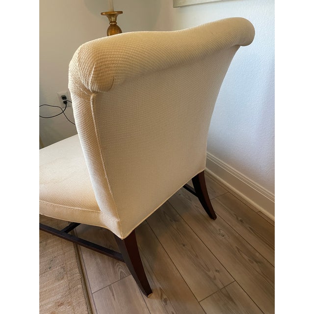 An elegant slipper chair designed by Barbara Barry for Baker Furniture, featuring a gently curved back, generous...