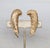 Late 1950s or early 1960s goldtone textured feather up the ear clip earrings. Marked "NAPIER PAT. PEND." on the clips and...