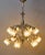 Elegant historic chandelier made of white brass with richly modeled decoration in the spirit of late historicism and...