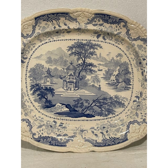 A fine 1820s-40s Blue and White English platter with gadrooned edge. The design features Chinese scenery, a popular motif...