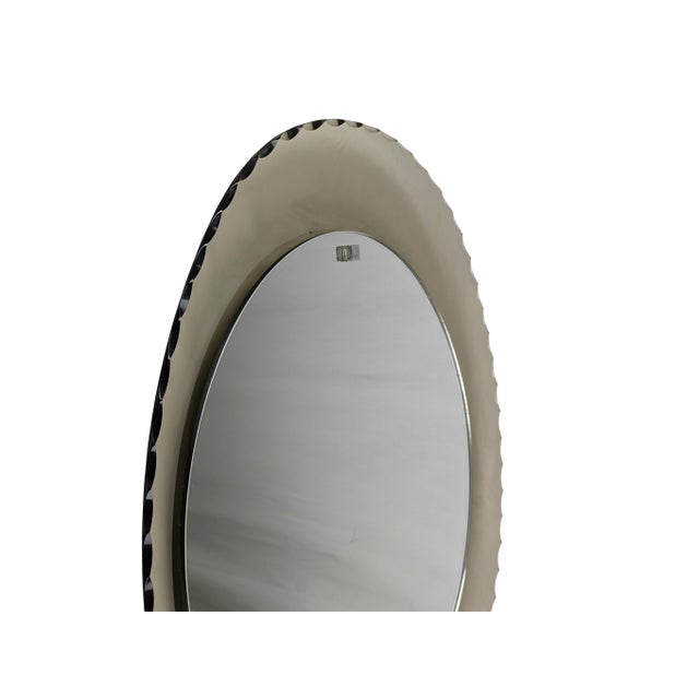 Beautiful oval wall mirror with convex smoked glass frame. The entire perimeter is decorated with a dense grinding work....