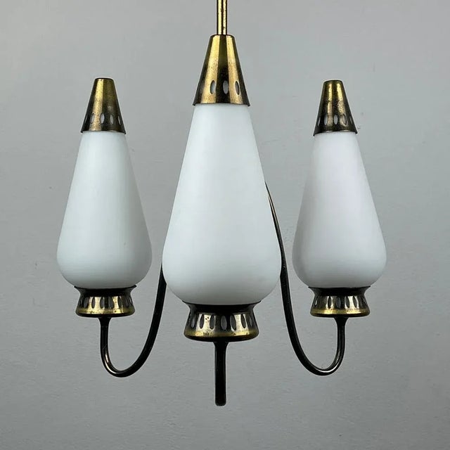 The beautiful 3 arm chandelier made of brass and milky glass, made in Italy in the 60s. If you are looking for a...