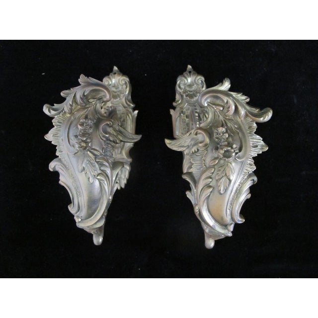 Set of 4 Rococo style antique brass curtain tie backs. Gilt metal showing ornate flower, foliage, and decorative motif....