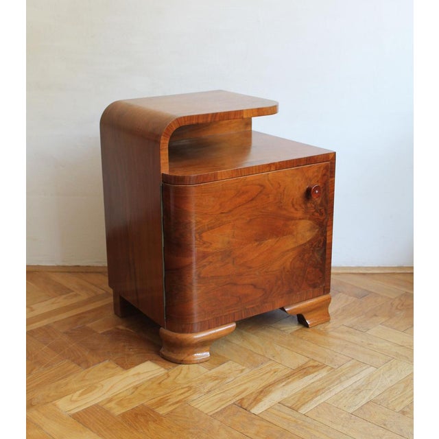 This 1930s bedside table is a fine example of Art Deco furniture at its most refined. Crafted in beech and richly veneered...