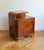 This 1930s bedside table is a fine example of Art Deco furniture at its most refined. Crafted in beech and richly veneered...