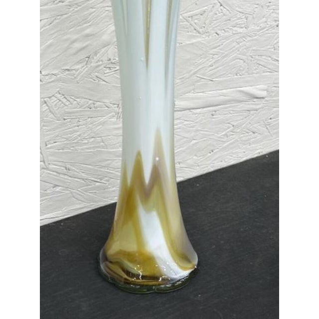 This vintage Italian art glass vase, reminiscent of Murano pieces from the 1960s, features a tall, slender trumpet shape....