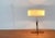 Very rare Mid Century table lamp by Kaiser lights with a special minimalist foot. The special detail of this luminaire is...