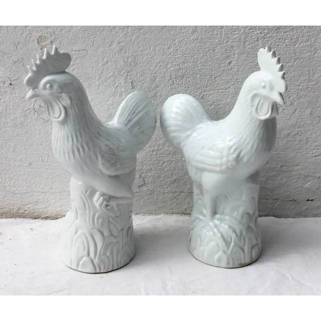 Pair of white ceramic roosters.