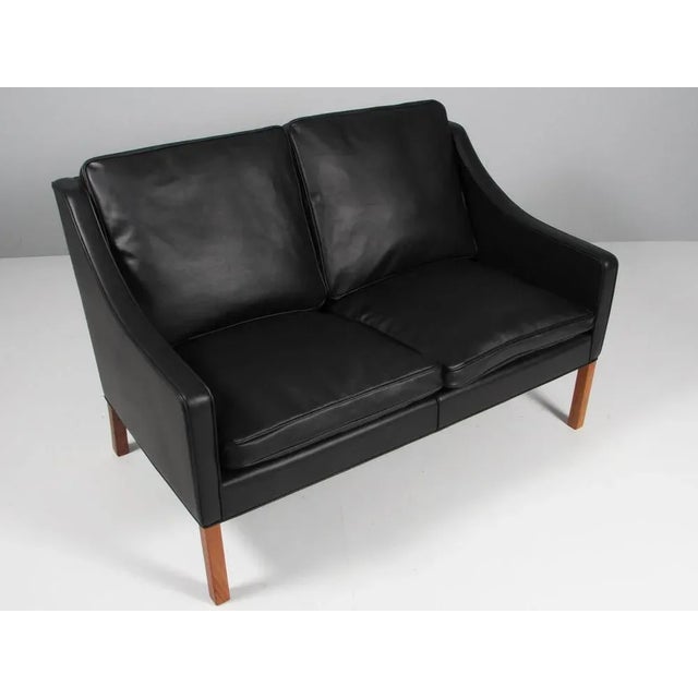 Børge Mogensen two-seat sofa new upholstery with black elegance aniline leather. Legs of teak. Model 2208, made by...