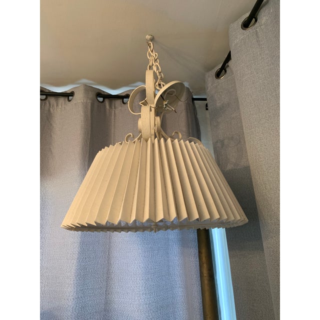 Vintage 1960s painted iron chandelier with decorative scrollwork and glass and fabric shade. Formally hung as a game table...