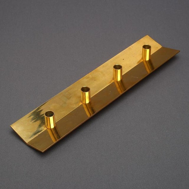 Elegant and refined brass candle holder designed by Pierre Forssell for Skultuna, Sweden, circa 1960s. This sculptural...