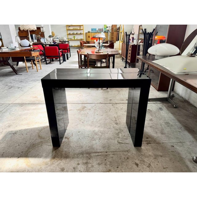 Extendable console table with metal frame and black lacquer finish, 1980s. modular structure consisting of a trestle base...