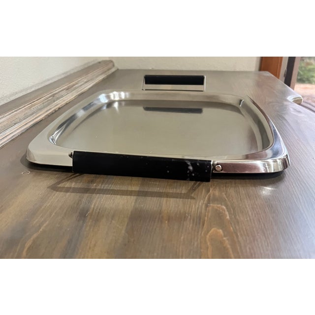 This mid century, stainless steel serving tray was made by Sears Roebuck and Simpsons-Sears. The lipped rim makes it...