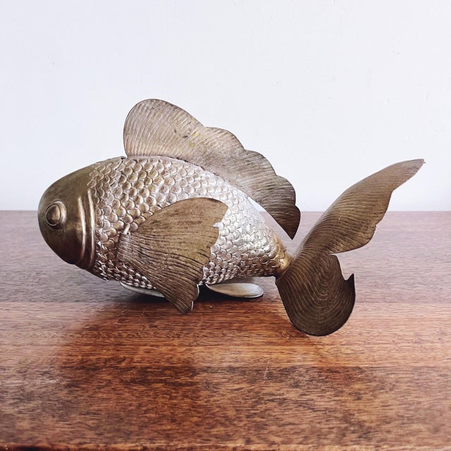 This is a vintage highly collectible handmade Cambodian silver plated copper fish with articulated, movable parts. The...