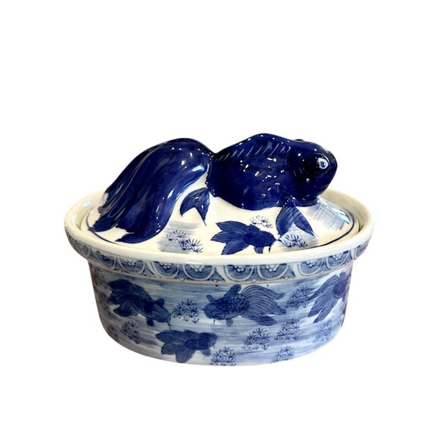 A lovely, vintage Chinoiserie koi fish vessel. Features a an oval form decorated in blue and white designs with a figural...
