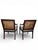Elegant pair of vintage cane-back accent chairs featuring carved mahogany-finished frames, fluted tapered legs, and...