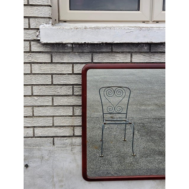 The 1920 mahogany round edge American mirror is an antique piece with a classic design that complements any room. The...