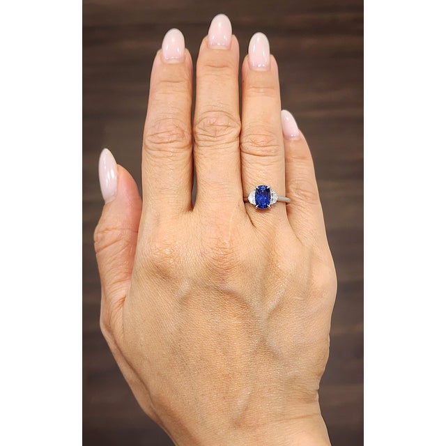 A captivating 1.97-carat GIA-certified natural cushion-cut sapphire commands attention with its deep blue hue. Accentuated...