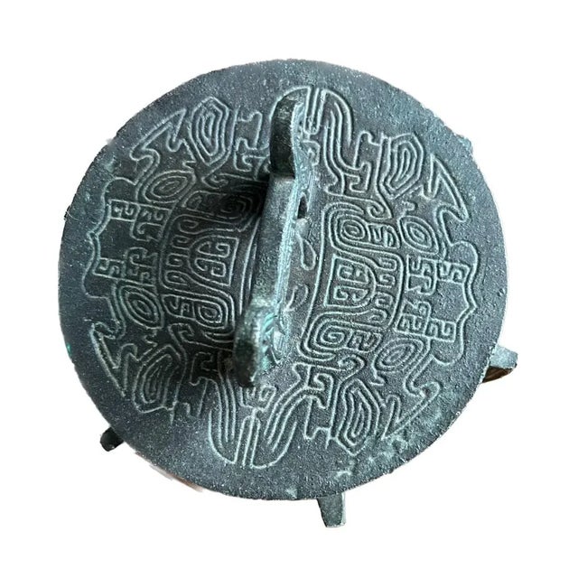 In the style of James Mont, this vessel in the form of a tripod-censor. James Mont was an American furniture designer and...