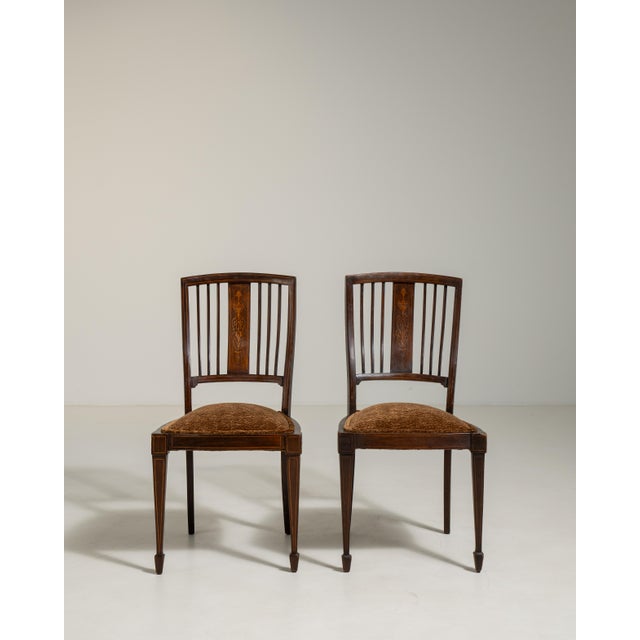 A refined pair of British chairs crafted in mahogany, featuring inlay work that reflects the neoclassical influence...