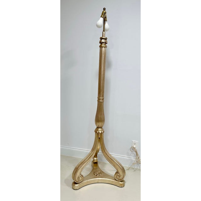 An elegant carved wood floor lamp by Nancy Corzine, finished in luminous silver leaf and reflecting the designer’s refined...