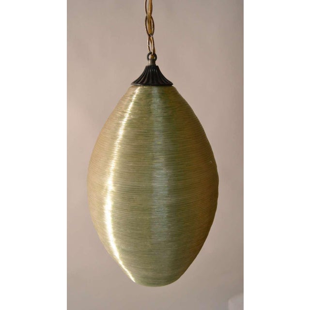 The textured spun fiberglass surface appears to be crystal color, but since the interior is green, it turns florescent...