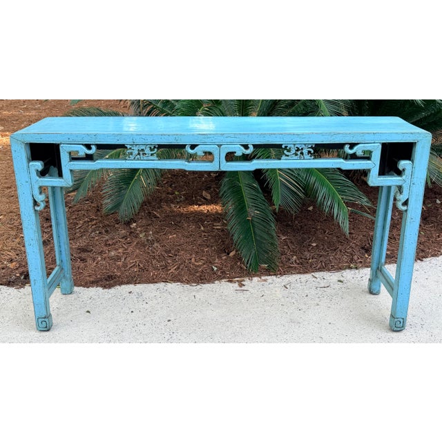 Blue lacquer graceful console table with support bars and wonderful carved design on each, etched detail on feet. Use in...
