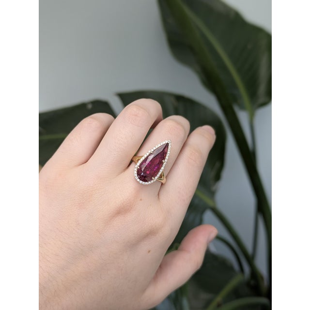 This stunning ring features a vivid 7.76-carat pear-shaped Rubellite Tourmaline, untreated and sourced from Brazil. Set in...