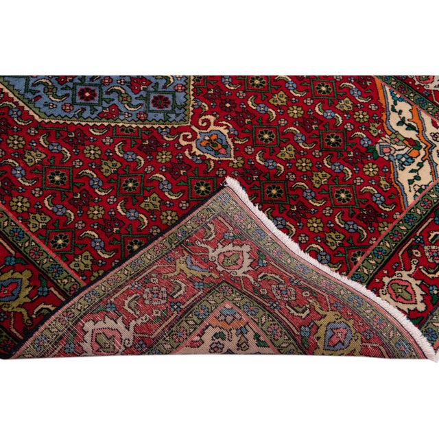 Beautiful Vintage Persian hand-knotted Wool rug with the red field. This Persian rug has a multicolor accents in all over...